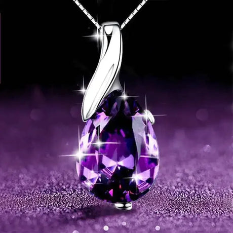 Purple teardrop pendant on a chain against a dark background