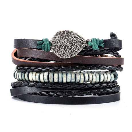 Stack of leather bracelets with leaf charm on a white background