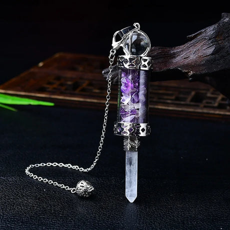Crystal pendant with purple stones on a dark background