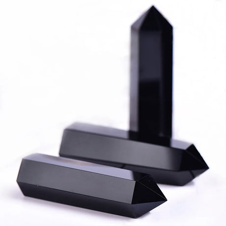 Two black crystal points on a white background
