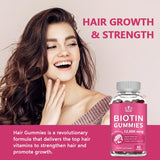 Woman with long hair next to a bottle of Biotin Gummies on a pink background