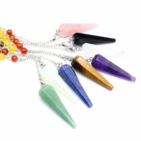 Set of crystal pendulums with colorful beads on a white background