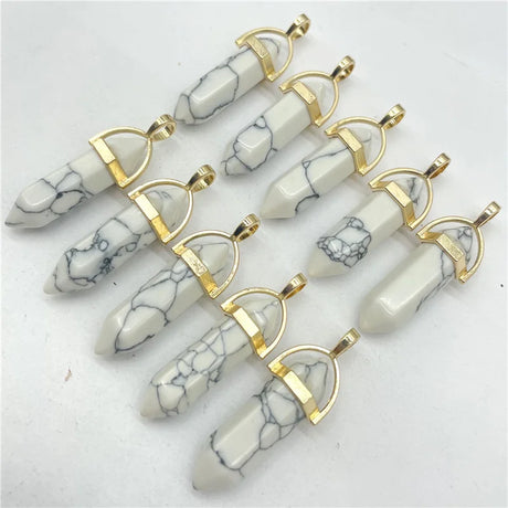 White marbled stone pendants with gold accents on a white background