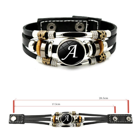 Black leather bracelet with metal accents and a central circular emblem on a white background.