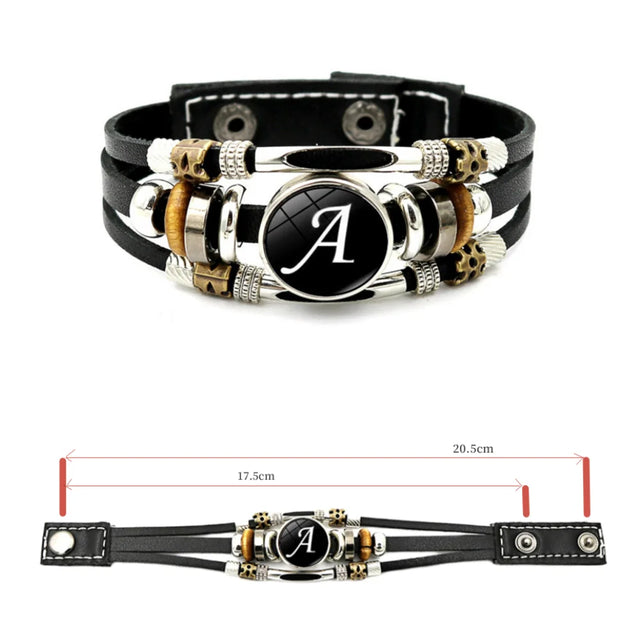 Black leather bracelet with metal accents and a central circular emblem on a white background.