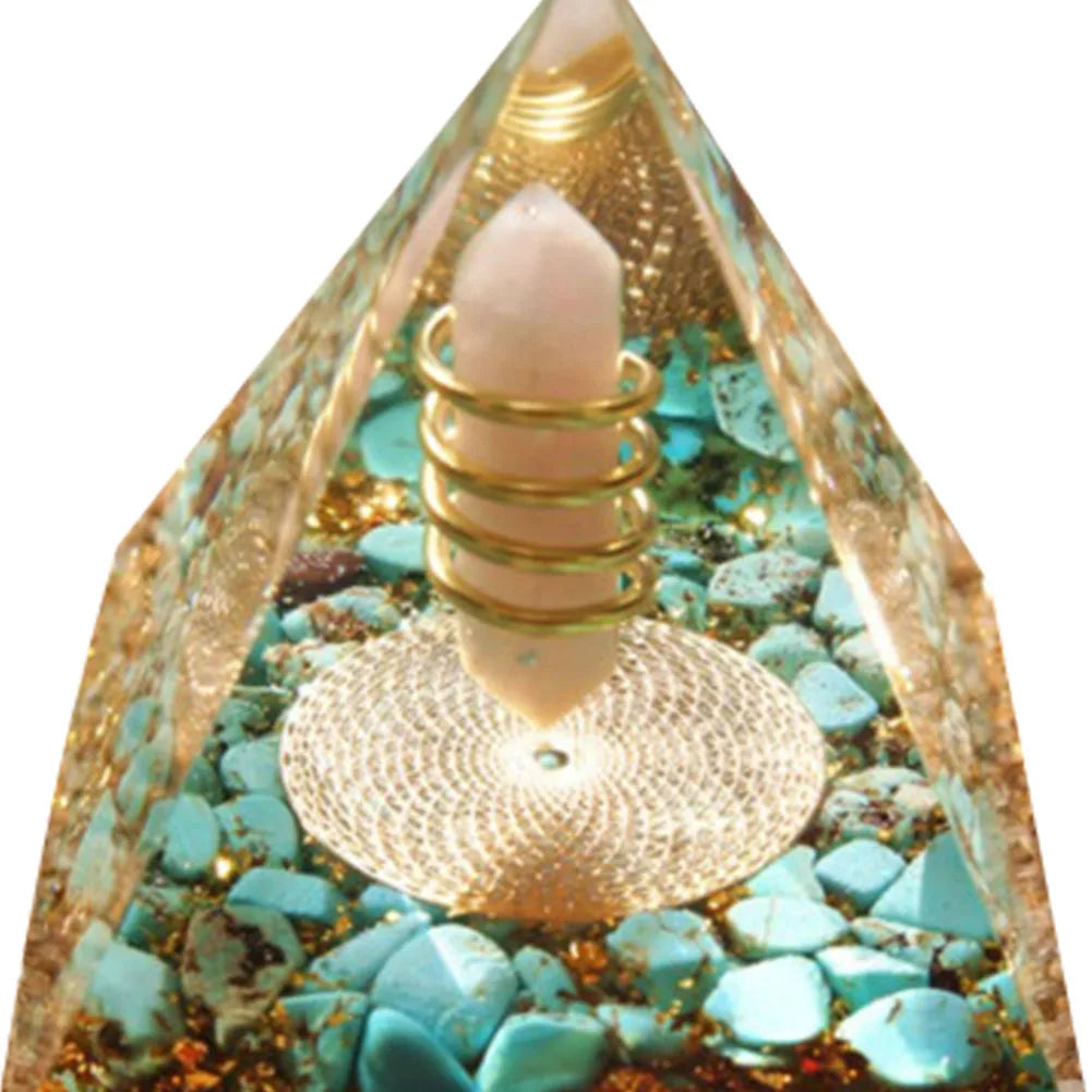 Decorative pyramid with turquoise stones and gold accents on a white background