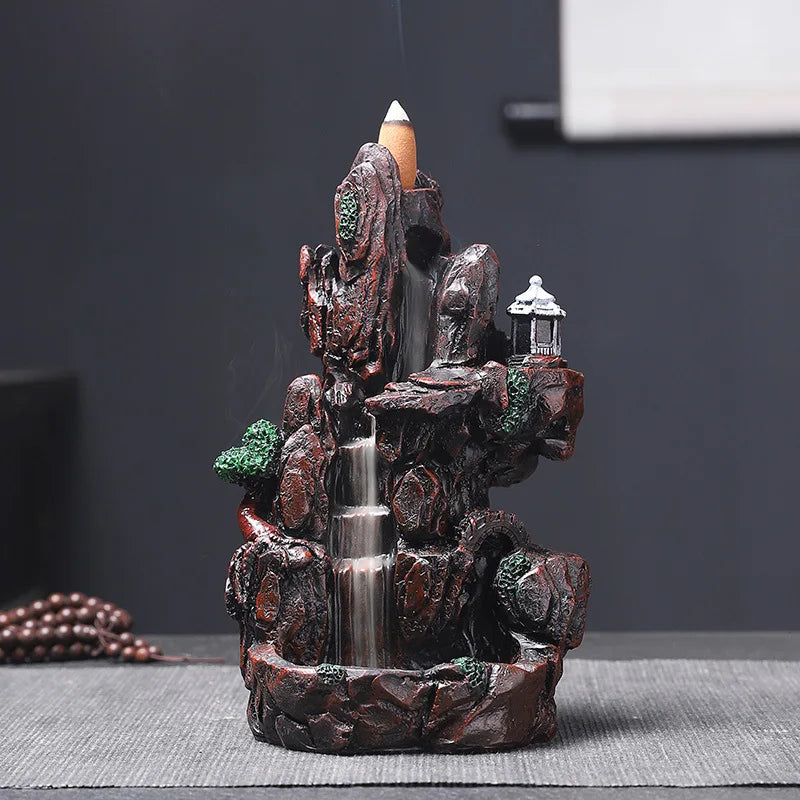 Decorative water fountain with rocks and a lantern on a dark background