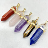 Five crystal pendants with gold accents on a white background
