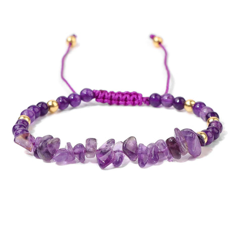 Purple beaded bracelet with gold accents on a white background