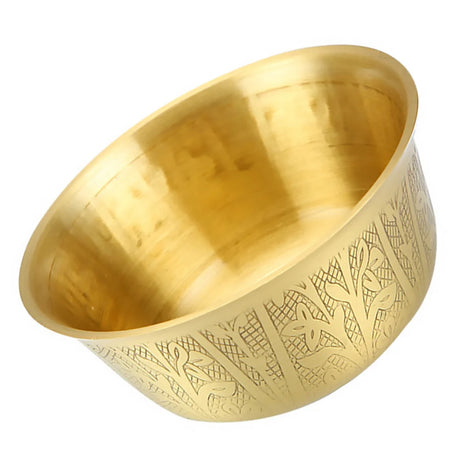 Gold bowl with intricate patterns on a white background