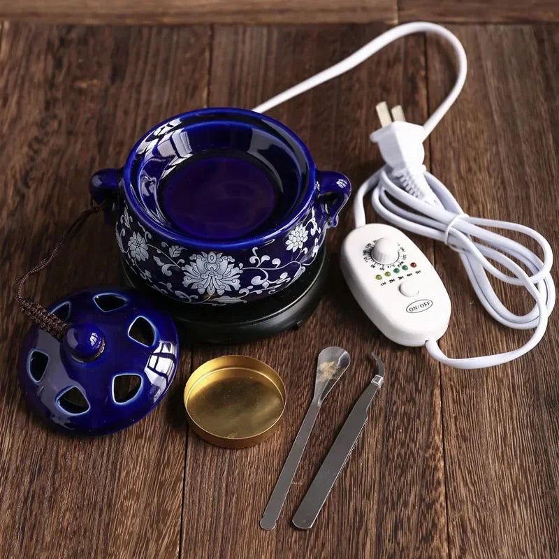 Blue ceramic bowl with floral design on a wooden surface, accompanied by a white power adapter and tools.