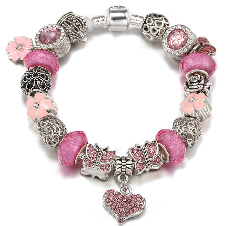 Bracelet with pink beads and charms on a white background
