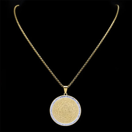 Gold necklace with a round pendant on a black background