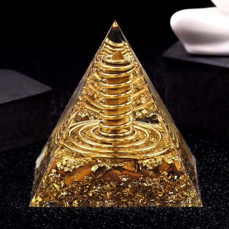 Crystal pyramid with a gold-like interior on a black background