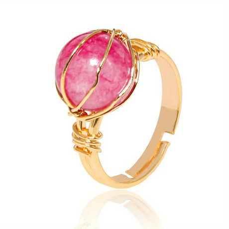 Gold ring with a pink gemstone on a white background