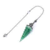 Green crystal pendant on a chain with a white background