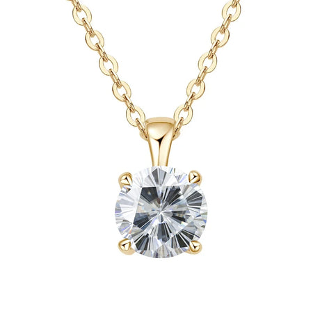 Gold necklace with a clear gemstone pendant on a white background