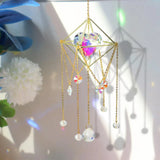 Decorative hanging crystal with gold chains and colorful beads on a blurred background