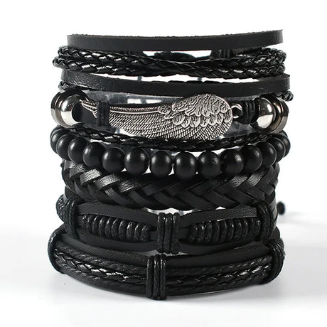 Stack of black leather and beaded bracelets on a white background