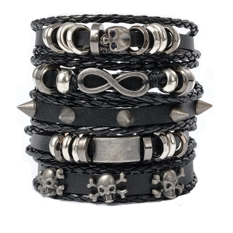 Stack of black leather bracelets with metal charms on a white background