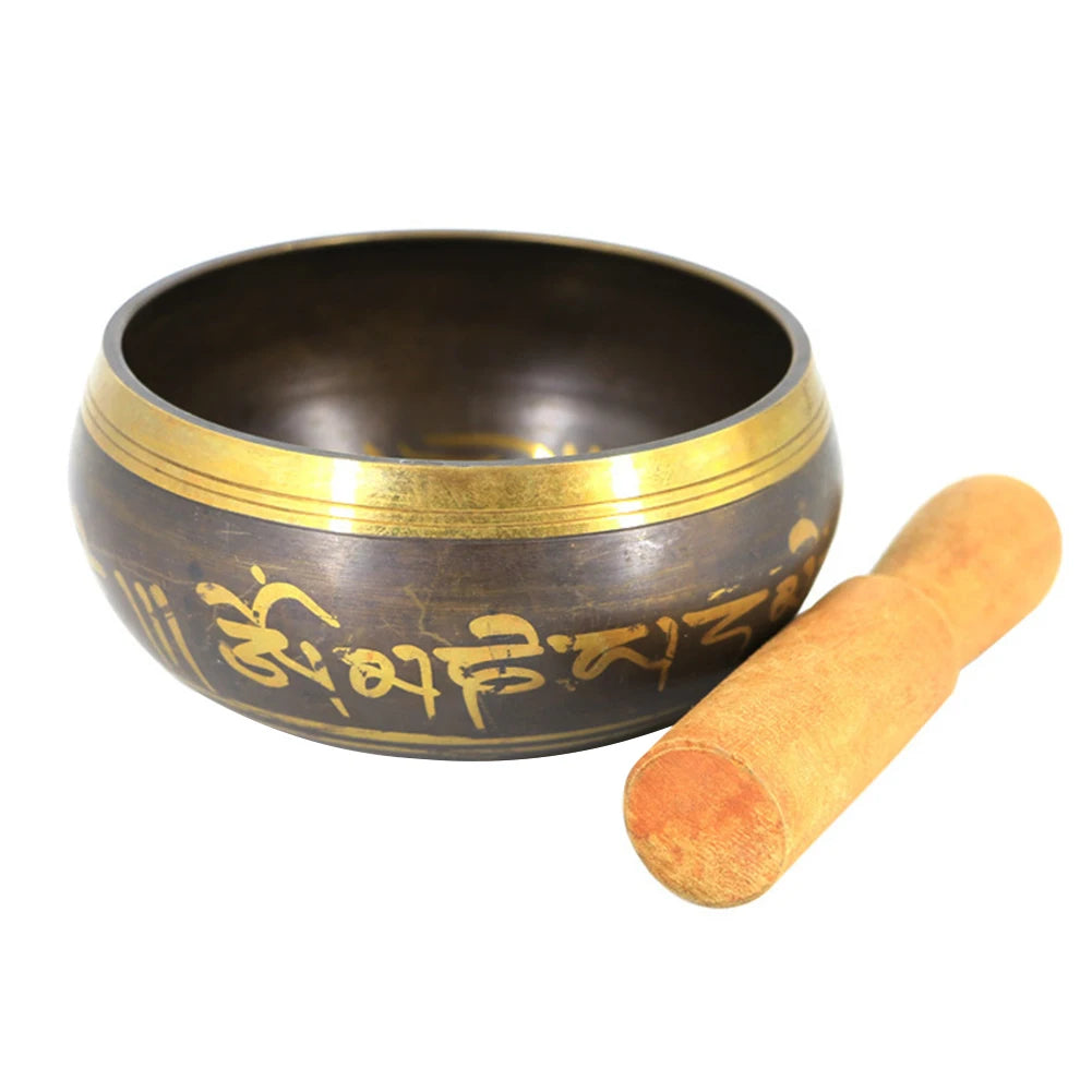 Tibetan singing bowl with gold rim and stick on a white background
