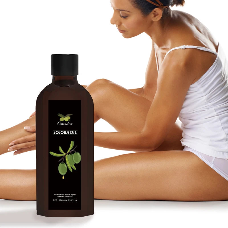 Bottle of Calendula Jojoba Oil with a woman applying oil to her arm on a white background