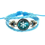 Blue braided bracelet with a snowflake charm on a white background