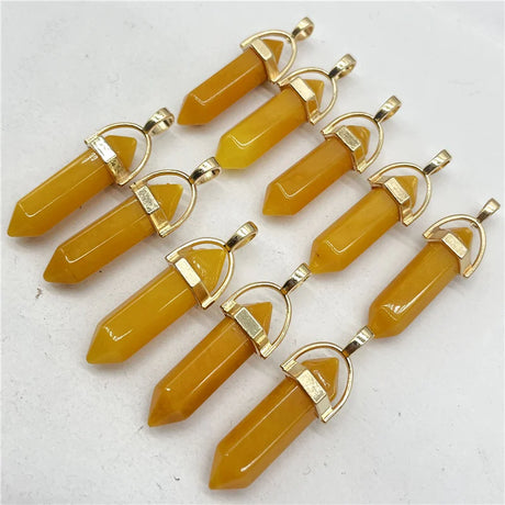 Yellow crystal pendants with gold accents on a white background