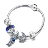 Silver bracelet with blue charms on a white background