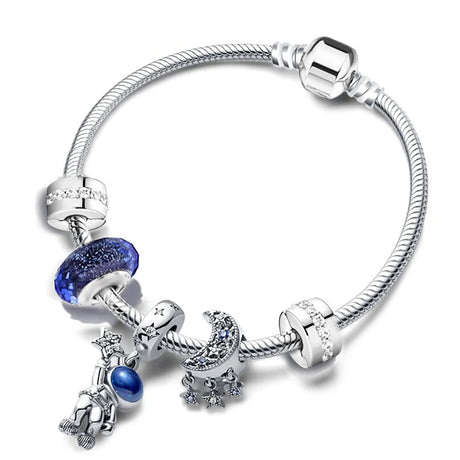 Silver bracelet with blue charms on a white background