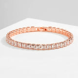 Rose gold bracelet with clear gemstones on a light gray background