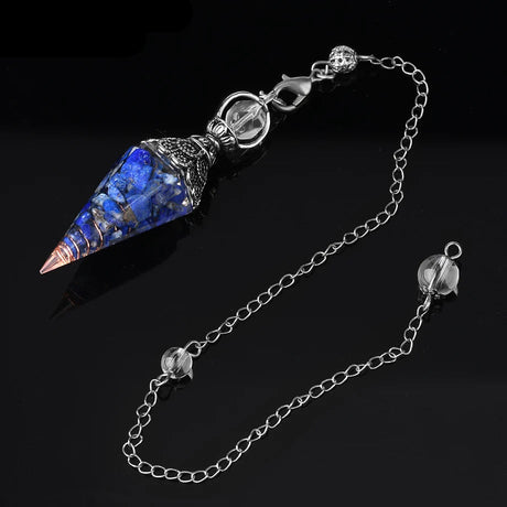 Blue crystal pendulum with chain on a black background