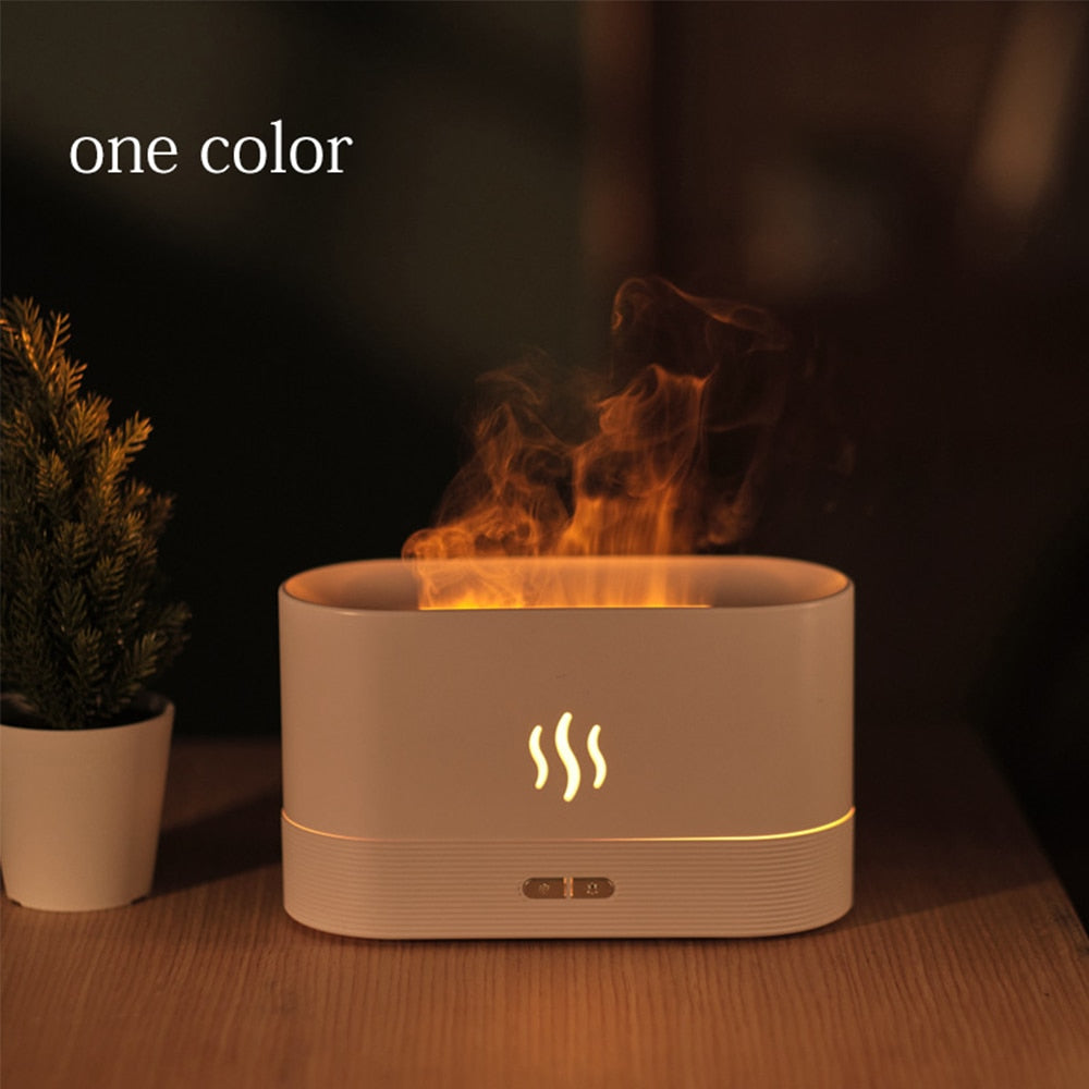 Tabletop fire pit with flames and a plant on a dark background