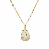Gold necklace with a white pendant on a white background