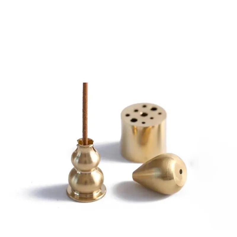 Three brass incense holders on a white background