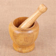 Wooden mortar and pestle on a beige fabric background