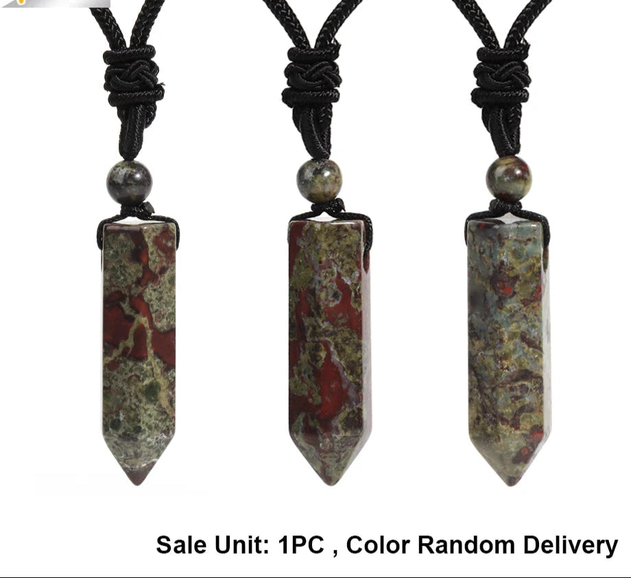 Three stone pendant necklaces on black cords with a white background