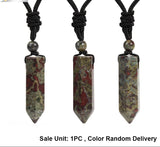 Three stone pendant necklaces on black cords with a white background