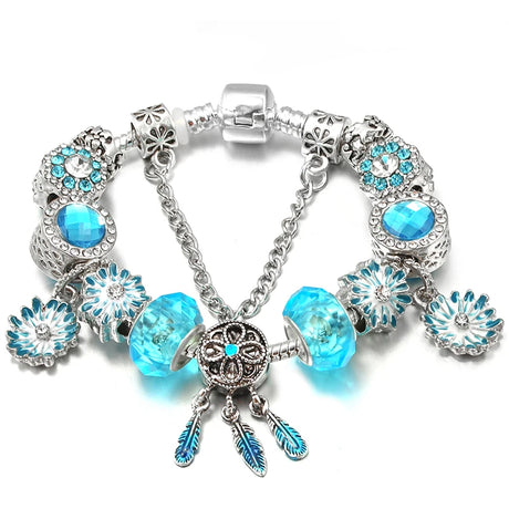 Silver bracelet with blue beads and charms on a white background