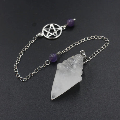 Crystal pendant with chain and pentacle charm on a dark background
