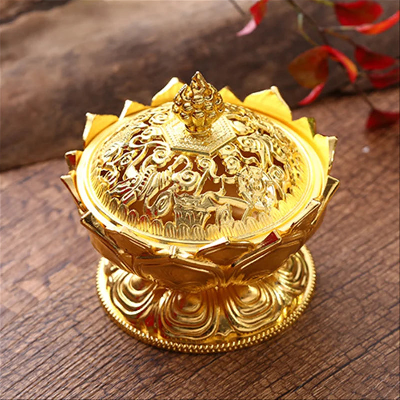 Gold decorative item with intricate designs on a wooden surface