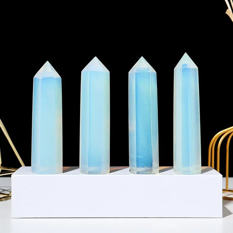 Five crystal towers with blue light on a white base against a black background