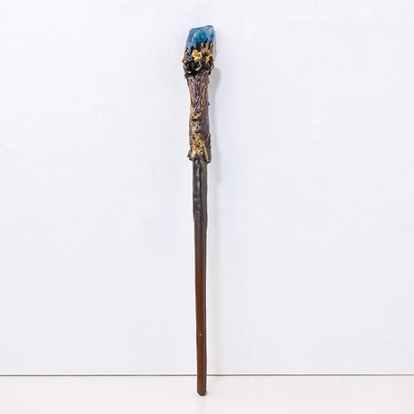 Decorative staff with a blue crystal top on a white background