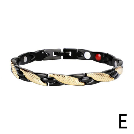 Black and gold chain bracelet with red accent bead on a white background