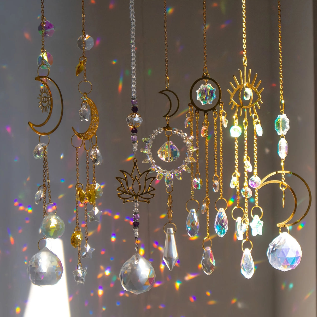 Decorative hanging crystals with celestial designs on a blurred background