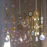 Decorative hanging crystals with celestial designs on a blurred background