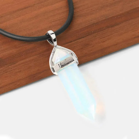 Necklace with a pendant featuring a blue stone on a wooden surface
