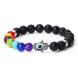 Multicolored beaded bracelet with a Hamsa hand charm on a white background
