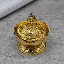 Gold decorative item on a gray surface