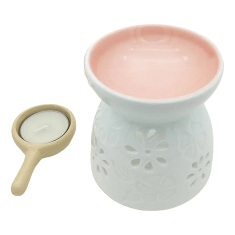 Ceramic wax warmer with a small candle on a white background